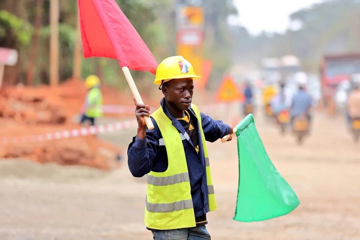 Flagman directing traffic at a construction site